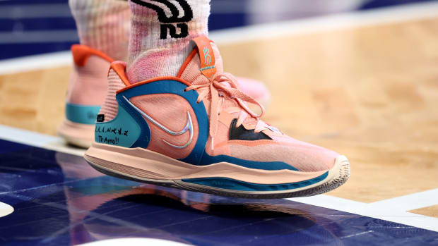 View of pink Kyrie basketball shoes.